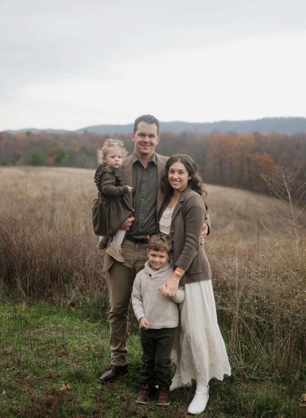 Nevade Eby with his family in a tree-lined field